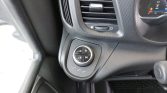 Circular drive mode selector on the center console with D and M buttons, located beneath the air vent, near the instrument cluster.