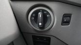 Dashboard headlight control knob set to auto with fog light indicator; small side panel dimmer to the right.