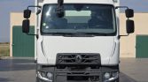 Front view of a white Renault heavy-duty truck parked on a paved lot, showing the grille, bumper, and large side mirrors.