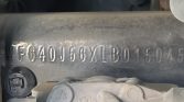 Close-up of a dusty engine block with a stamped alphanumeric serial/VIN code visible: VF64OJ56YXBD01304 (part of the engine).