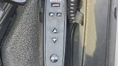 Vertical Renault control panel on the door trim with up/down arrow buttons and a MEM memory button, likely for seat or mirror adjustments.