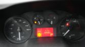 Dashboard cluster showing speedometer left, tachometer right, central red display reading ECO, 64528 km, gear in P, with warning lights on.