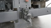 Tow hitch ball mounted on a gray metal bumper, ready to attach a trailer.