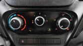 Dashboard climate control: left temperature knob blue to red, center fan speed dial, right air distribution dial, A/C indicator lit.