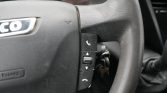 Steering wheel with vertical phone control buttons (answer, up/down arrows) for hands-free calling in a car interior.