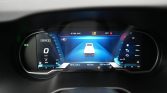 Digital car dashboard showing 0 km/h with central vehicle icon in a blue tunnel style display.