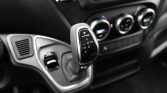 Gear selector lever in a modern car interior showing P R N D and +/- for manual shift