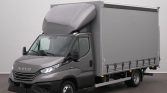 Gray Iveco delivery truck with a tall gray cargo box and raised cab, parked indoors.