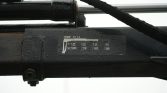 Close-up of a wet hydraulic crane cylinder with a measurement scale and HIAB label visible on the side.