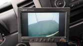 Car backup camera display showing the rear view to assist parking.