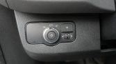 Car headlight control cluster: rotary dial for headlights with Auto option, and a right-side fog light button with a brightness slider.