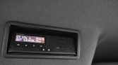 In-car Mercedes‑Benz trip computer showing 0 km/h and total distance 140,498.2 km on the dashboard display