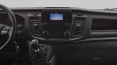 Interior of a vehicle dashboard with center console, gear shift, and radio display visible.