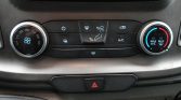 Climate control panel: left knob adjusts fan speed, center buttons control airflow and defrost, right knob sets temperature with blue/red scales and A/C active (Max A/C) and hazard button below