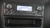 In-dash car radio display showing BRABANT with control buttons for Radio, Media, Tel, and Setup nearby.