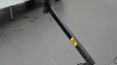 Black trailer jack leg extended from a trailer hitch, resting on a paved surface; yellow label shows MAX 820 KG.