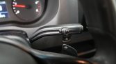 Steering-column gear selector with R N D P indicators on a car interior, plus a nearby paddle shifter labeled +/-.