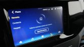 Infotainment touchscreen in a car showing the Phone app: Recents, Contacts, Keypad; a synchronization message 'Failed to read your recents and contacts' with a 'Synchronizing' button and car icons at the bottom edge.