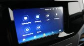 In-dash car infotainment touchscreen showing icons for Apple CarPlay, Mobile Link, Radio, User Manual, System Settings, and Albums.