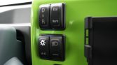 Close-up of a lime-green dashboard with gear selector buttons showing D, N, R and Eco/Work mode.