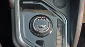 Car center console with circular EV gear dial showing R N D and a red indicator, plus vertical mode buttons (ECO, PWR) on the right.
