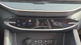 Center car climate control panel with fan, AC, recirculation, and airflow icons, plus heated seat/defrost indicators and USB ports below.