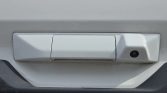 White car tailgate handle with a right-side built-in backup camera, mounted on the bumper area