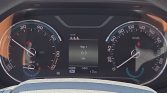 Car instrument cluster: speedometer on right, tachometer on left, center display shows Trip 1 at 0.3 km, gear in neutral and 17 km total.
