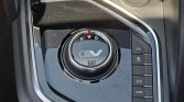 Close-up of EV drive mode dial with R N D indicators and a row of vertical function buttons (ECO, PWR) on the right side of the center console.