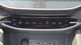 Car climate control panel with fan, airflow icons, heated seats, A/C, and dual-zone controls; USB ports below.