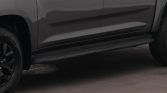 Gray pickup truck side view showing the running board/side step and black wheels.