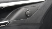 Car interior door panel with round mirror-adjustment knob labeled L and R (driver’s side)