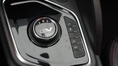 Circular gear selector in a car center console showing R N D indicators and an EV badge, with Eco and Power mode buttons to the right.