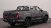 Grey SAIC Maxus T90 EV double-cab pickup viewed from rear-right, with covered truck bed and black alloy wheels