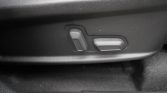 Power seat controls on a car seat: a vertical lever and a horizontal slider.