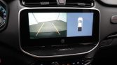 Car backup camera display: left panel shows parking lines, right panel shows a top-down bird’s-eye view of the car.