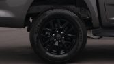 Close-up of a black alloy wheel and tire on a vehicle, showing the rim and tread detail from the side view.