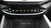 Center console climate controls with illuminated icons for fan, air direction, recirculation, power, A/C, and seat heaters; USB ports below.