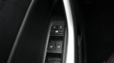 Driver-side door panel with power window controls and lock buttons.