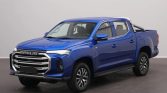 Blue Maxus pickup truck, double-cab, angled three-quarter view showing front grille and chrome accents