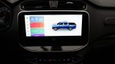 Car's infotainment touchscreen showing colorful app icons and a blue pickup truck graphic on the home screen