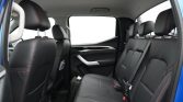 Rear passenger seats in a modern SUV with black leather and red contrast stitching