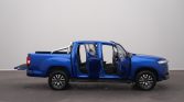 Blue pickup truck photographed in a studio with all doors open, exposing the interior seats and cabin outlines.