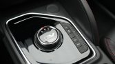 Rotary gear selector on a glossy center console with EV emblem and Eco/Pwr buttons nearby.