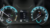 Car instrument cluster with speedometer on the right and tachometer on the left; center screen shows Trip 1 and 0.0 km, gear N, 159 km remaining.