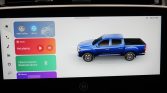Infotainment screen with a blue pickup graphic on the right and colorful tiles on the left for CarPlay, QLink, Media (Not playing), Bluetooth connect, and Albums.