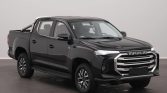 Black Maxus double-cab pickup truck, front three-quarter view, indoors in a studio.