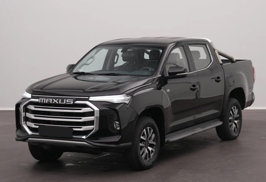 Black Maxus pickup truck in a studio, front three-quarter view with chrome grille and wide bumper