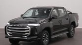 Black Maxus pickup truck in a studio, front three-quarter view with chrome grille and wide bumper