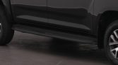 Side view of a dark gray pickup truck showing the running board and front/rear wheels at the bottom edge of the image